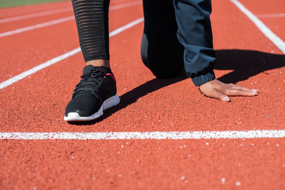 Sprinter in the starting blocks on the track