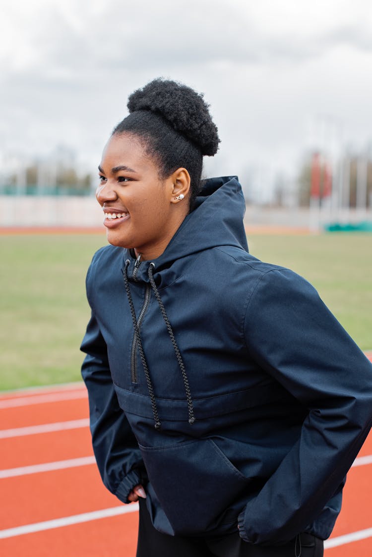 Woman In Dark Blue Jacket Smiling