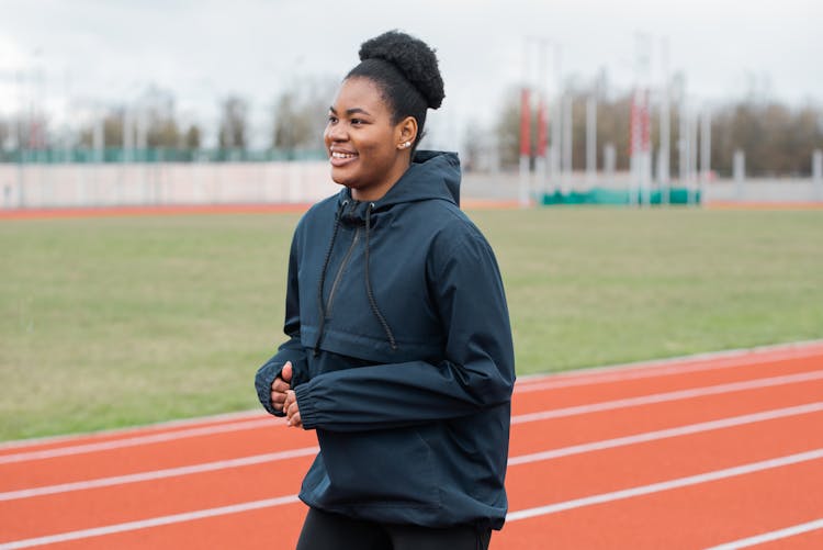 Woman Athlete Training On The Track And Field