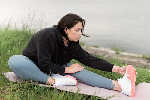 Girl sitting beautiful woman in yoga pants hi-res stock