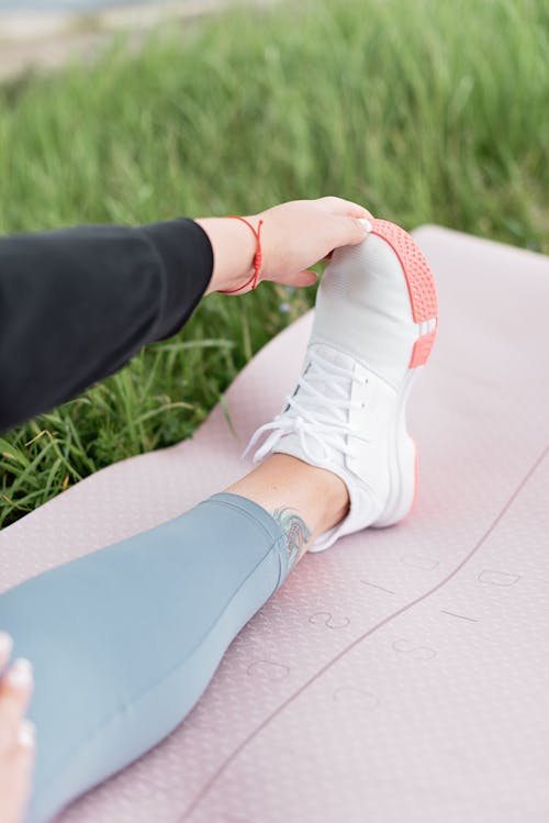 Person in White Low Top Sneakers