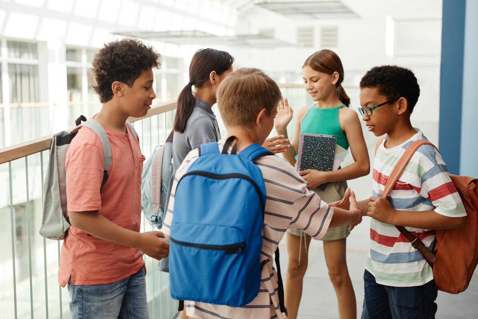 Students having a conversation in a school hallway