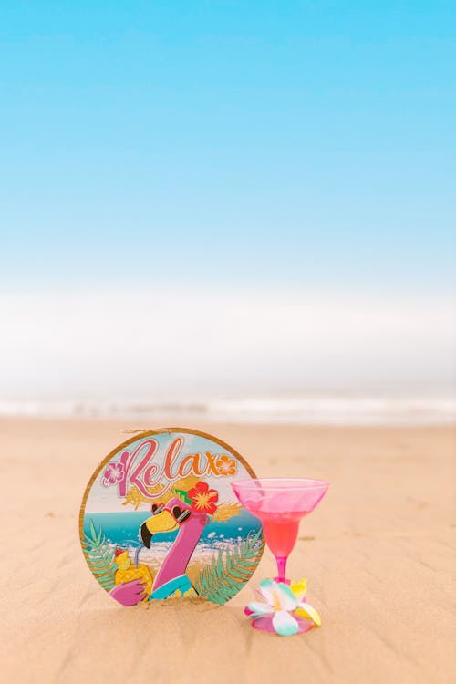 Free Pink Cocktail Glass on the Sand Stock Photo