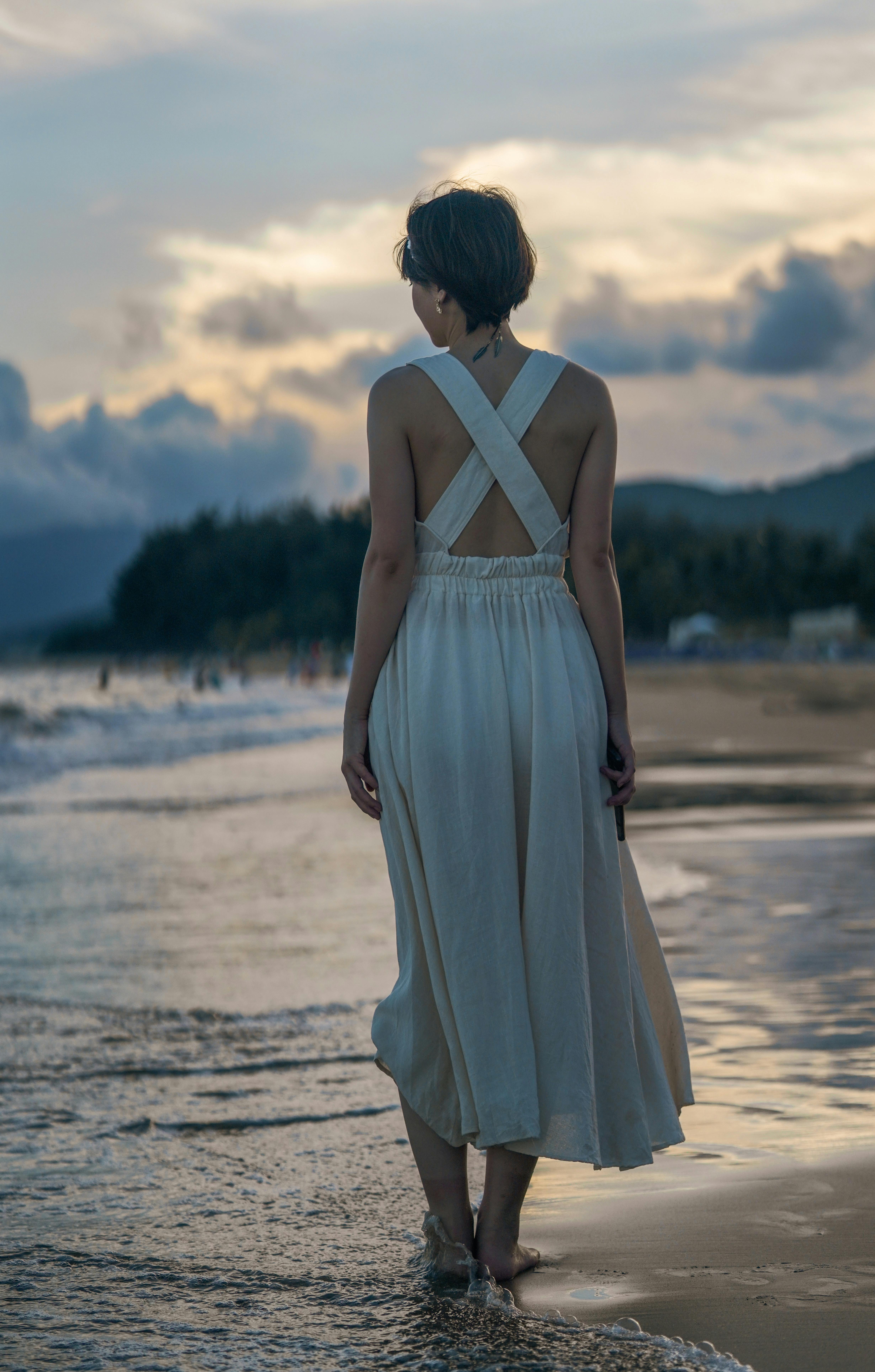Woman in Long Dress Walking on a Sandy Beach  Free Stock Photo