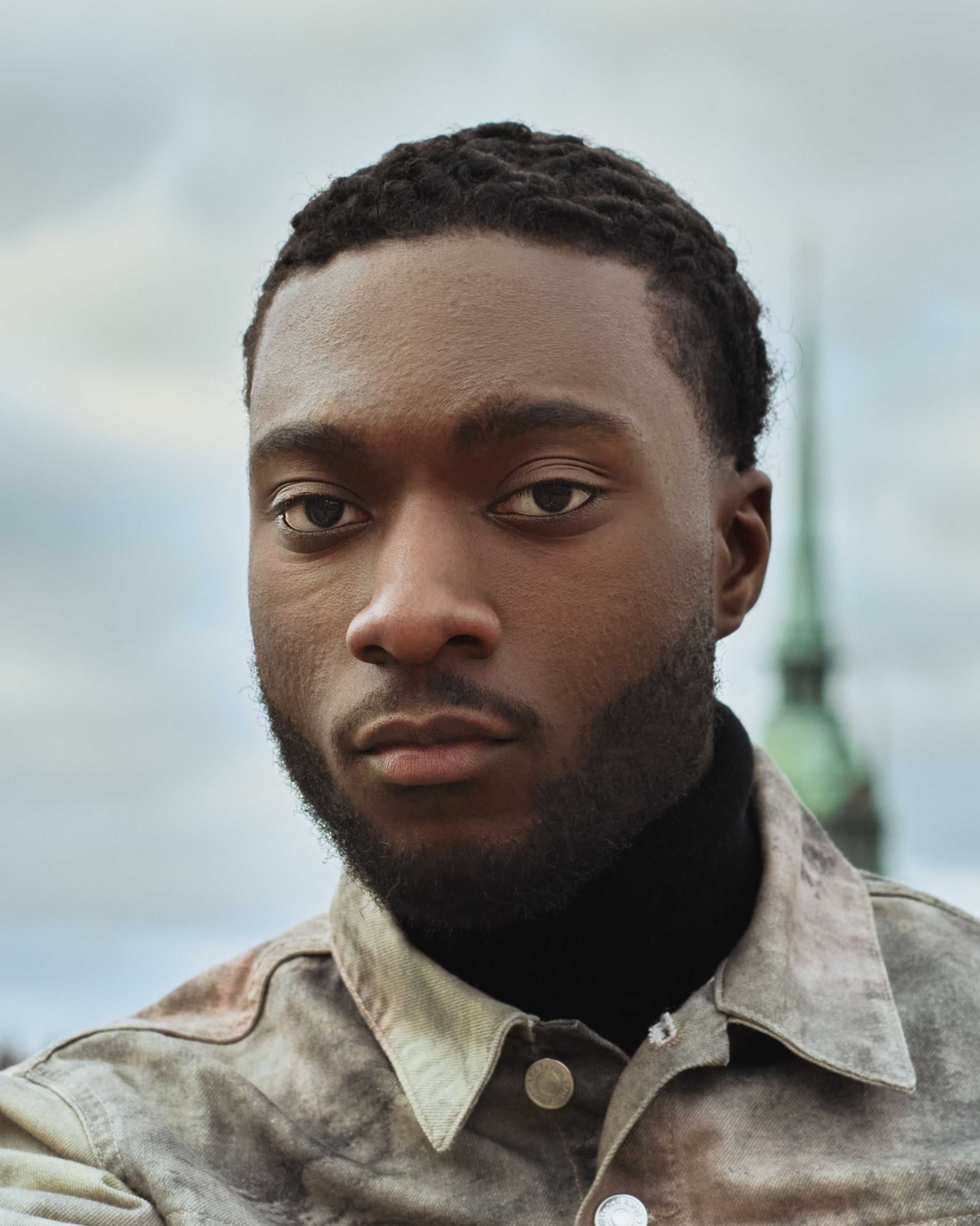 Close-up portrait of a man with architectural background in Stockholm, Sweden.