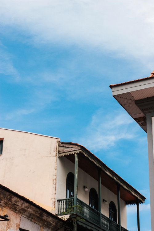 Free Elegant historic buildings with balconies set against a clear blue sky. Stock Photo