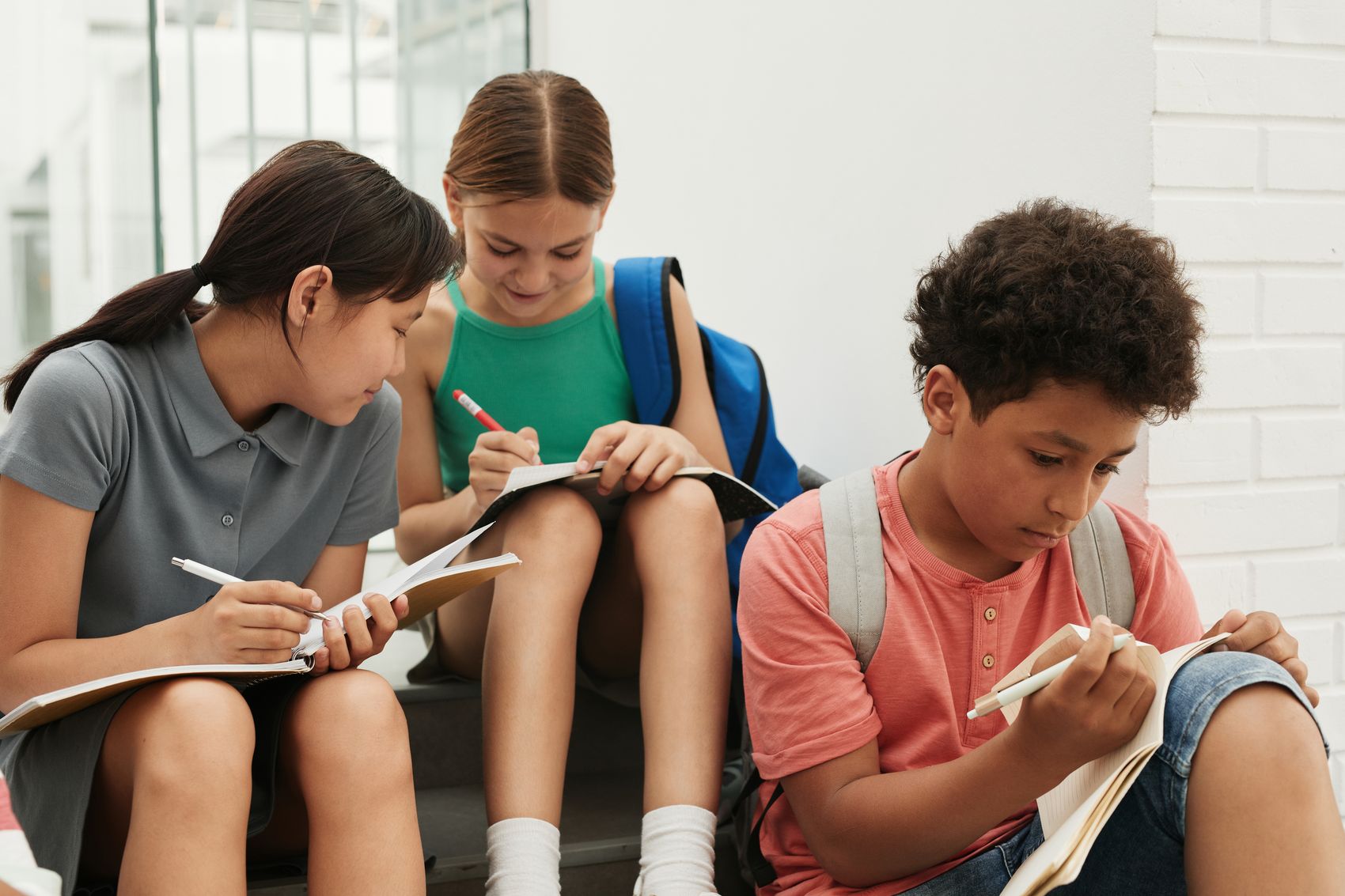 Three children doing their homework together
