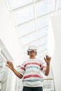 Man in White Red and Blue Striped Polo Shirt Wearing Black Cap