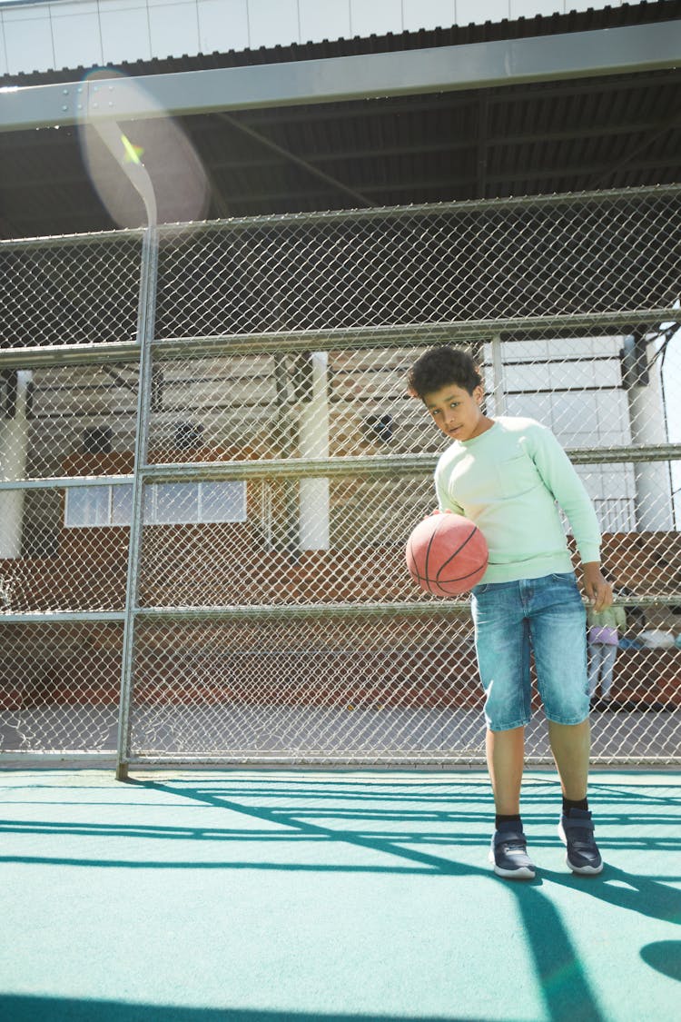 A Boy Holding A Basketball