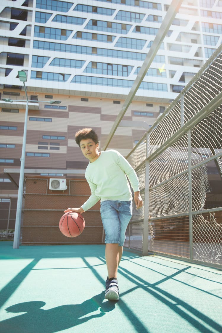 Boy Dribbling A Ball