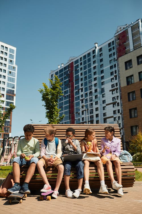 Boys and Girls Sitting on a Bench