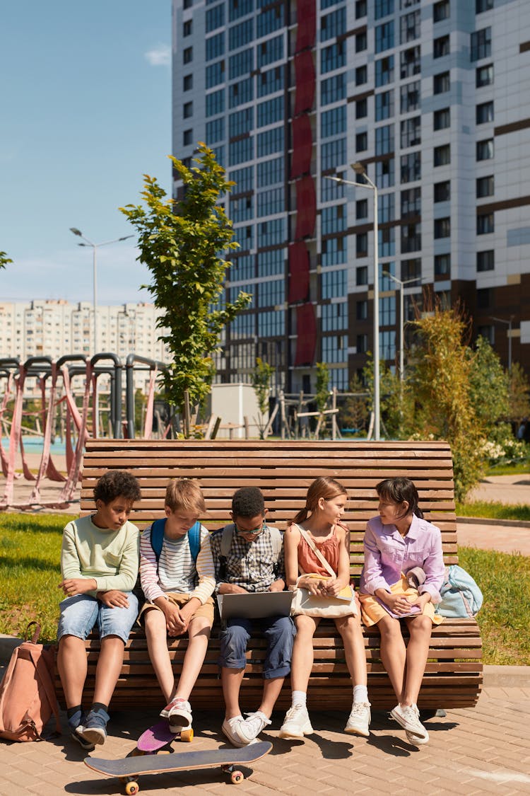 Kids Sitting On A Bench Together