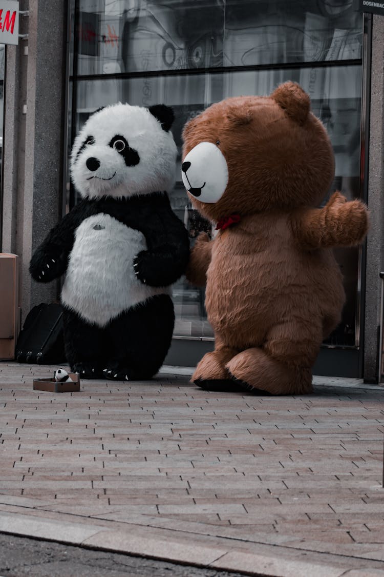 Bear And A Panda Mascots Dancing In The Street