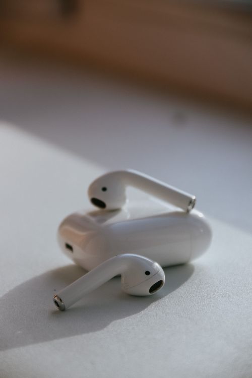 Free Close-up of wireless earbuds on a light surface, showcasing sleek modern design. Stock Photo