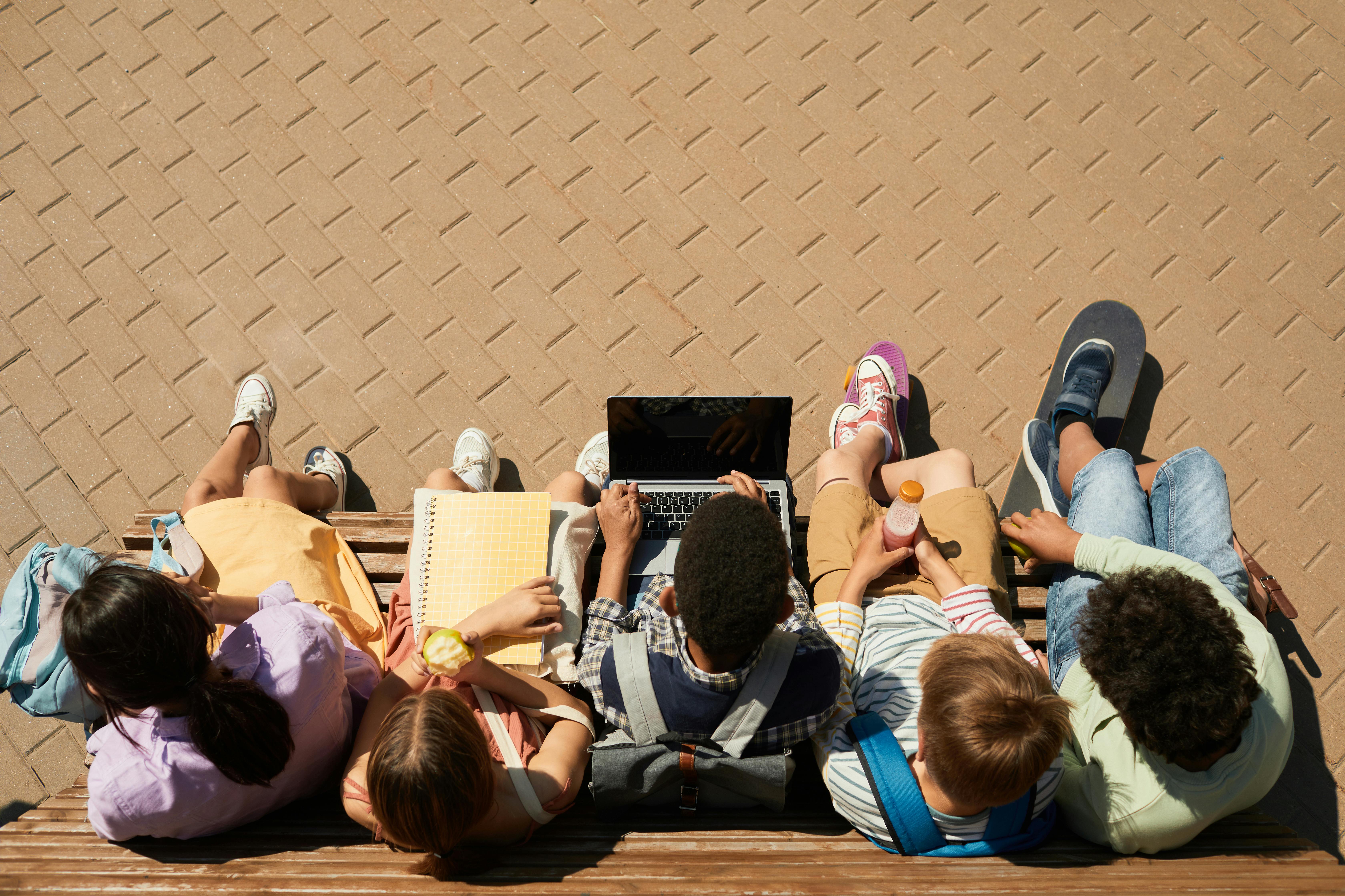 Free Classmates Sitting on a Bench Stock Photo