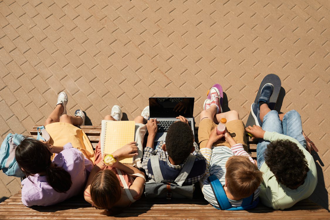 Free Classmates Sitting on a Bench Stock Photo