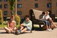 2 Boys Sitting on Brown Wooden Bench