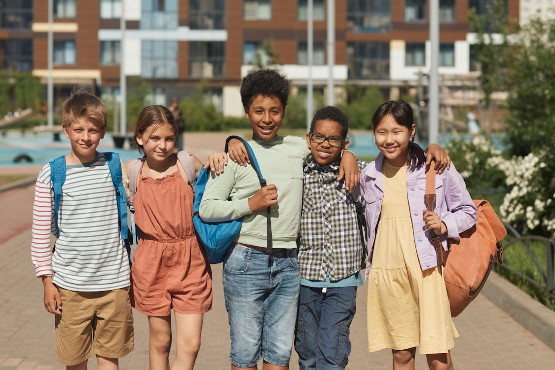 Free Group of Students Standing Next to Each Other while Smiling at the Camera Stock Photo