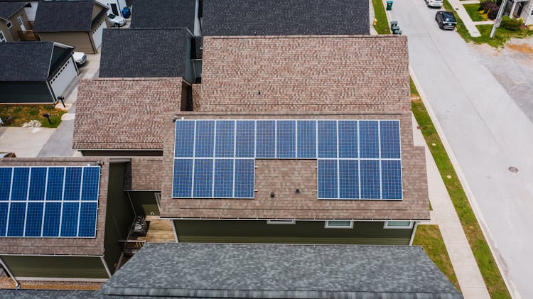 Solar Panels On Tiled Roofs Of A House