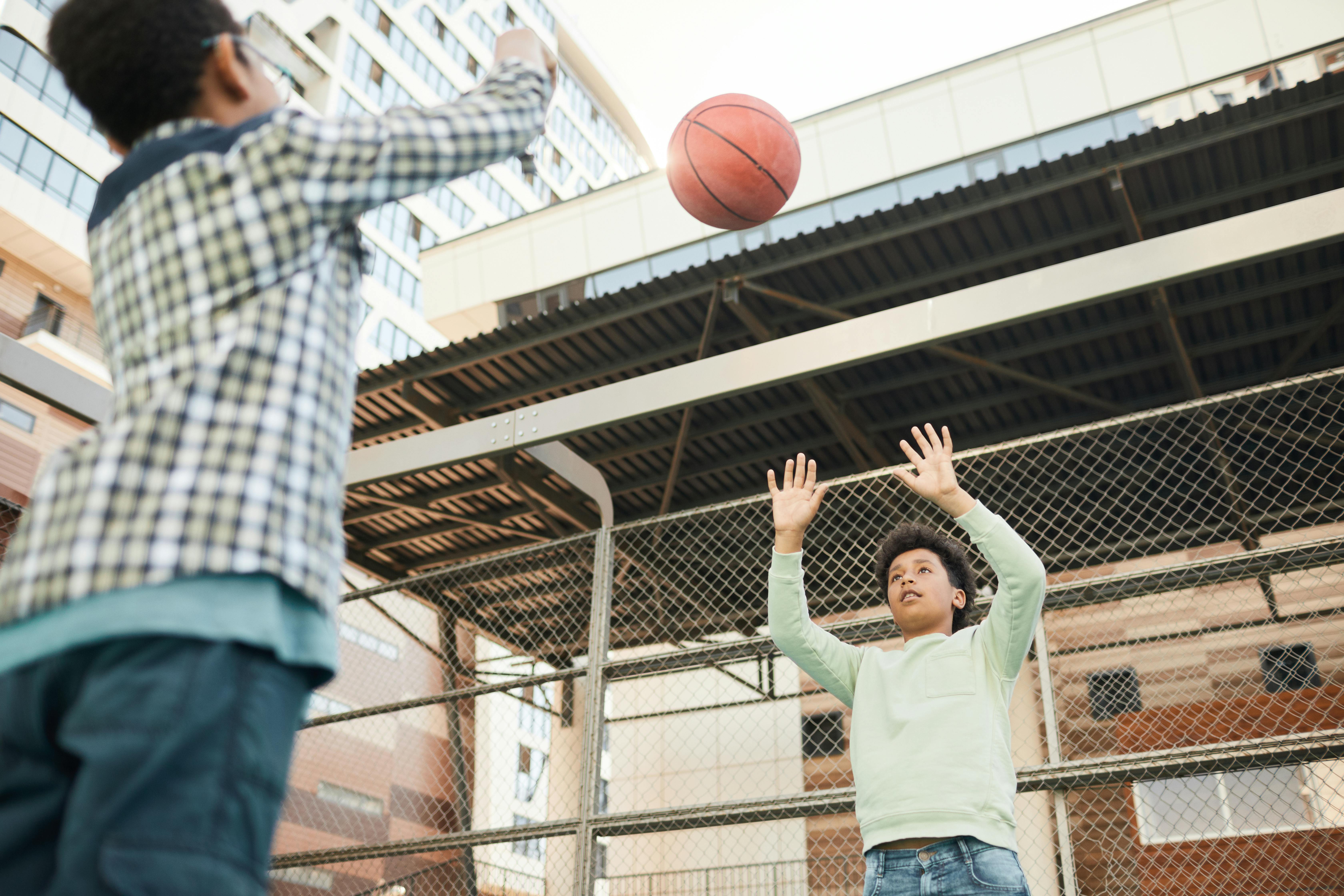 low angle shot of young boys busy playing basketball