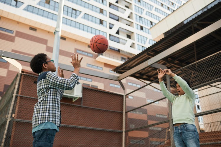 Boys Throwing A Basketball Ball Between Each Other 