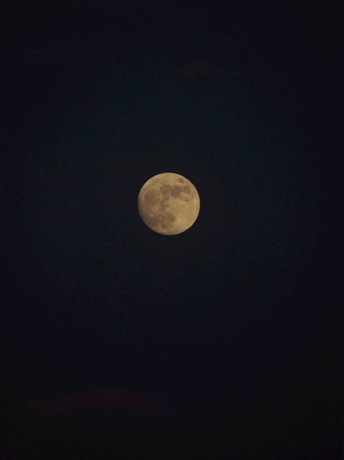 Moon illuminating on dark night sky