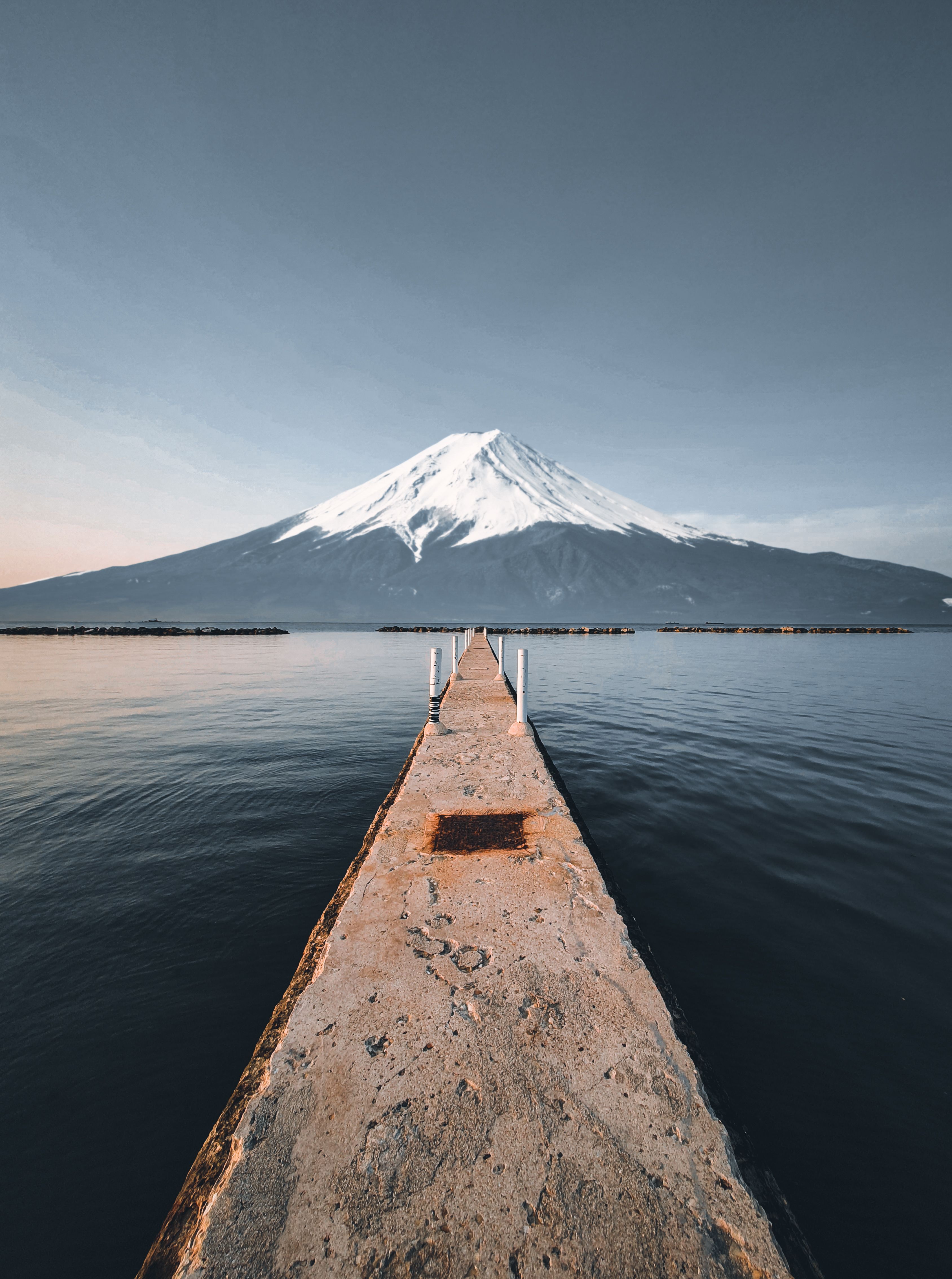 Pier in Water near Winter Mountain · Free Stock Photo