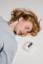 A Fearful Woman Lying Down while Overcoming Her Fear of Cockroaches