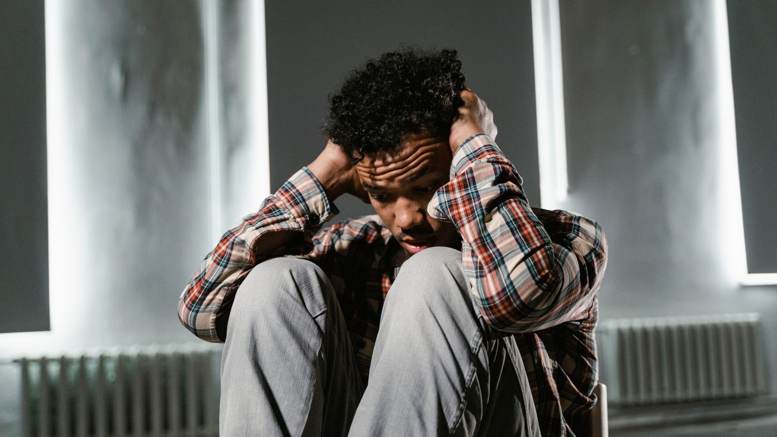 A man sitting with his head in his hands