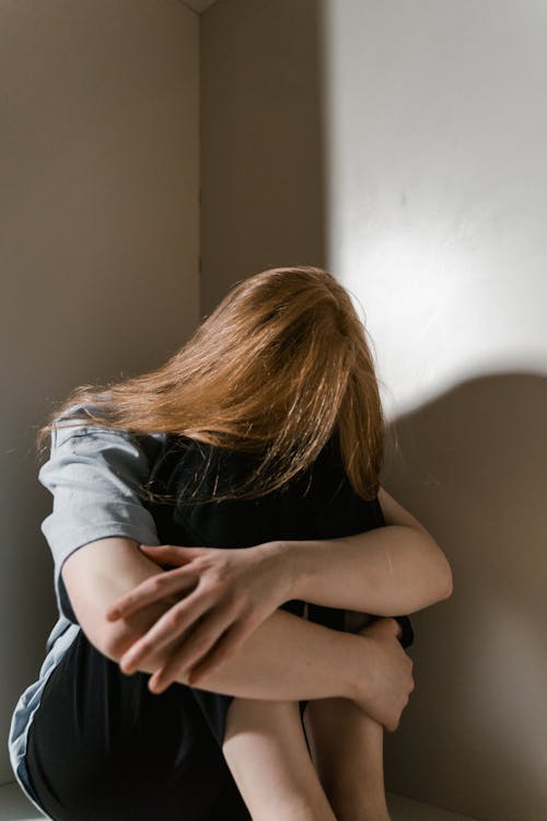 Free A Lonely Woman Sitting by Herself Stock Photo