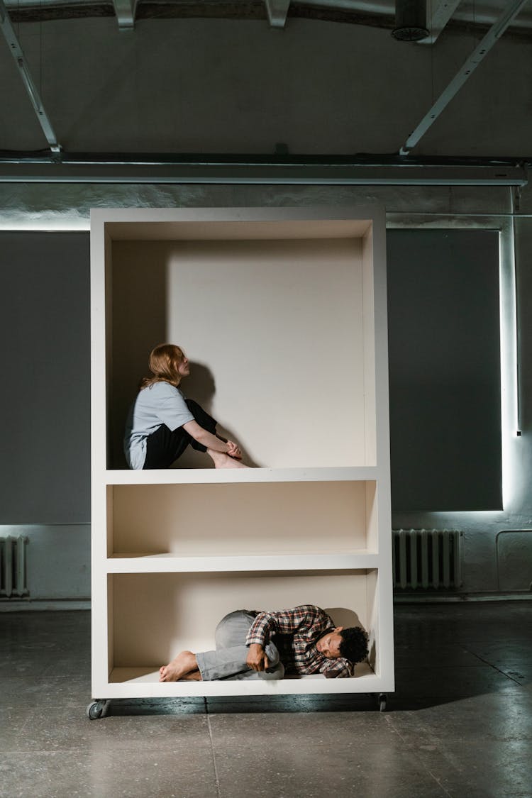 A Man And Woman Looking Lonely In A Cabinet