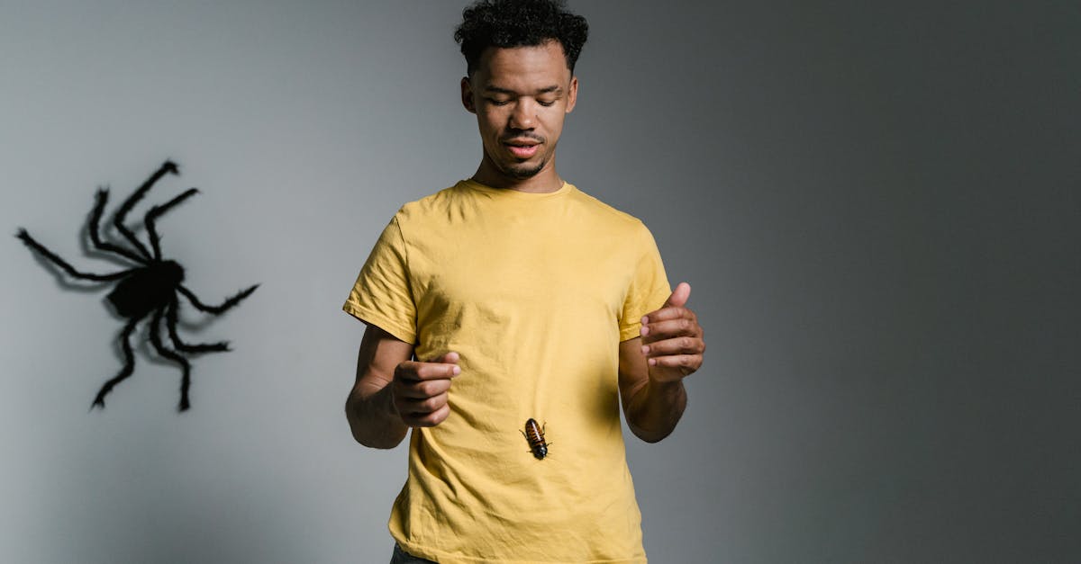 Man confronts phobia with cockroach on shirt; tackling fear and anxiety