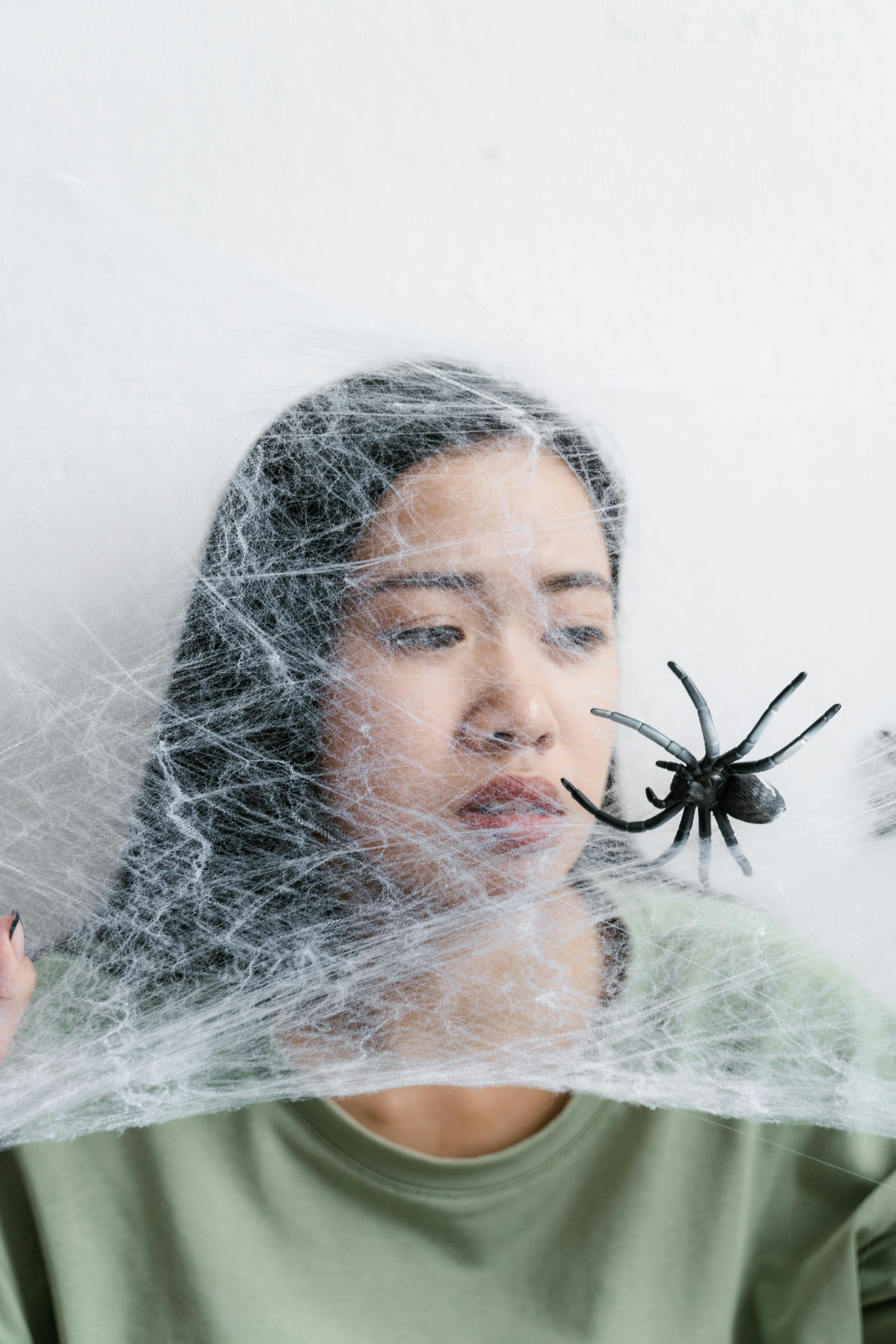 a helpless woman trapped in a spider web