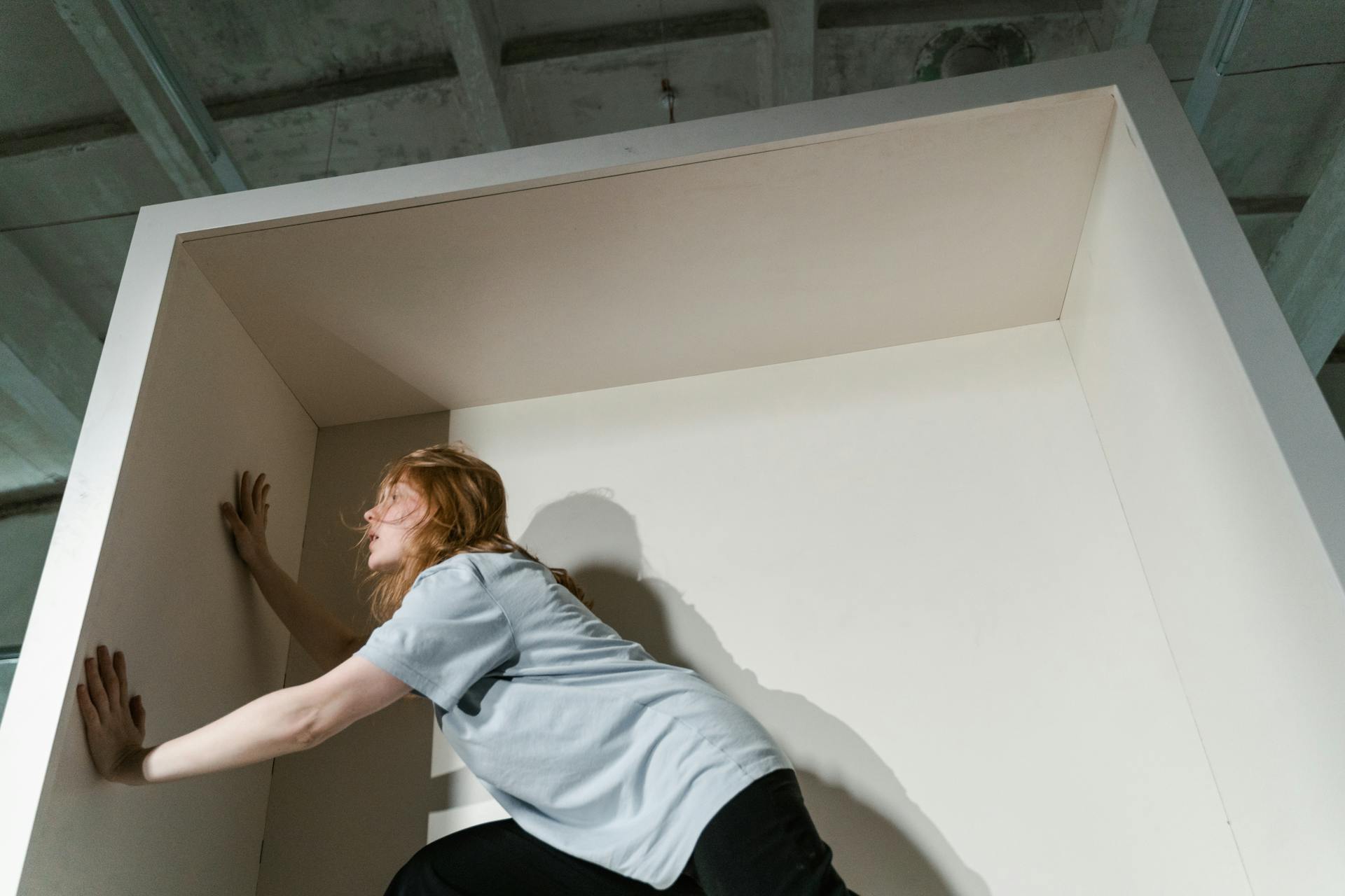 A Fearful Woman Having Claustrophobia in a Cabinet