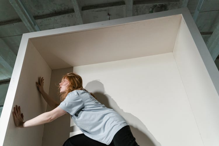 A Fearful Woman Having Claustrophobia In A Cabinet