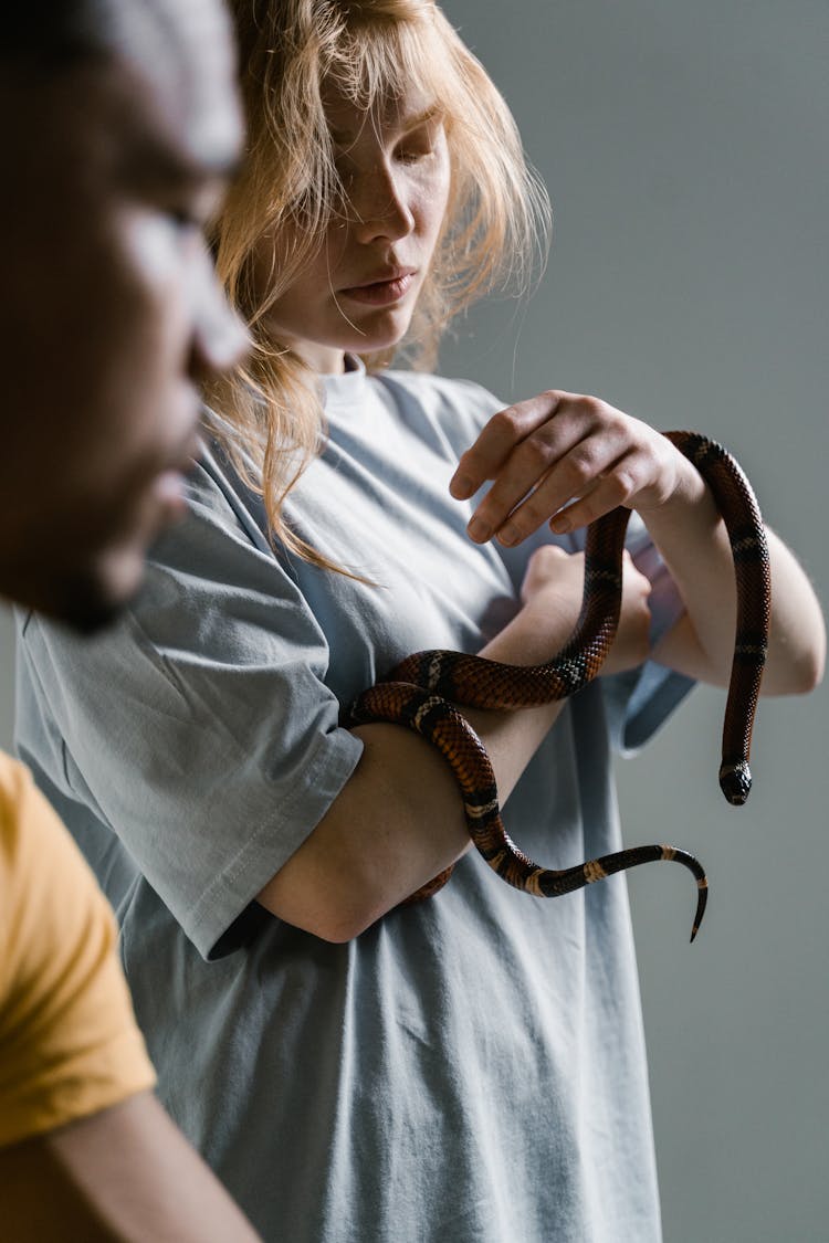 A Woman Overcoming Her Fear Of Snakes