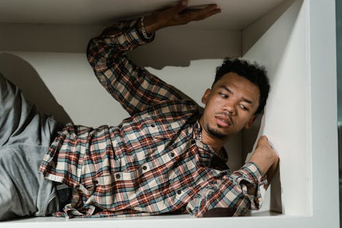 A Fearful Man Having Claustrophobia in a Cabinet