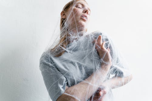 A Helpless Woman Trapped in a Spider Web