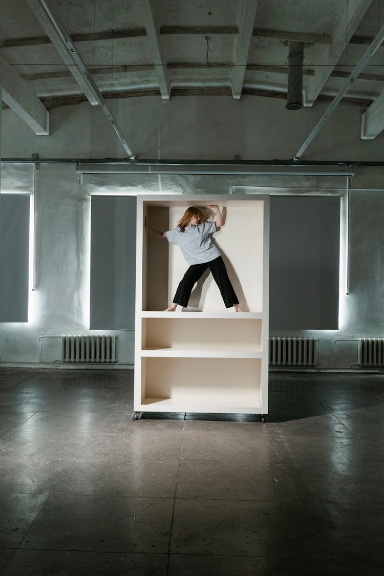 A Fearful Woman Having Claustrophobia In A Cabinet