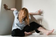 A Fearful Woman Having Claustrophobia in a Cabinet