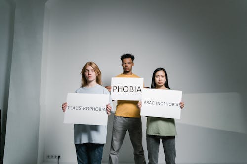 People Holding Signs of Different Forms of Phobia