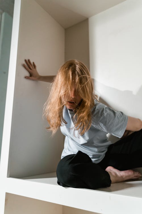 A Fearful Woman Having Claustrophobia in a Cabinet