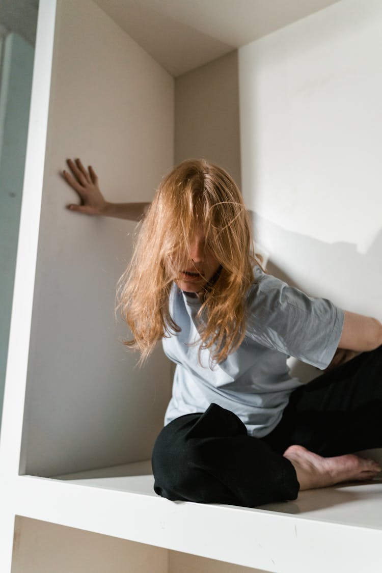 A Fearful Woman Having Claustrophobia In A Cabinet