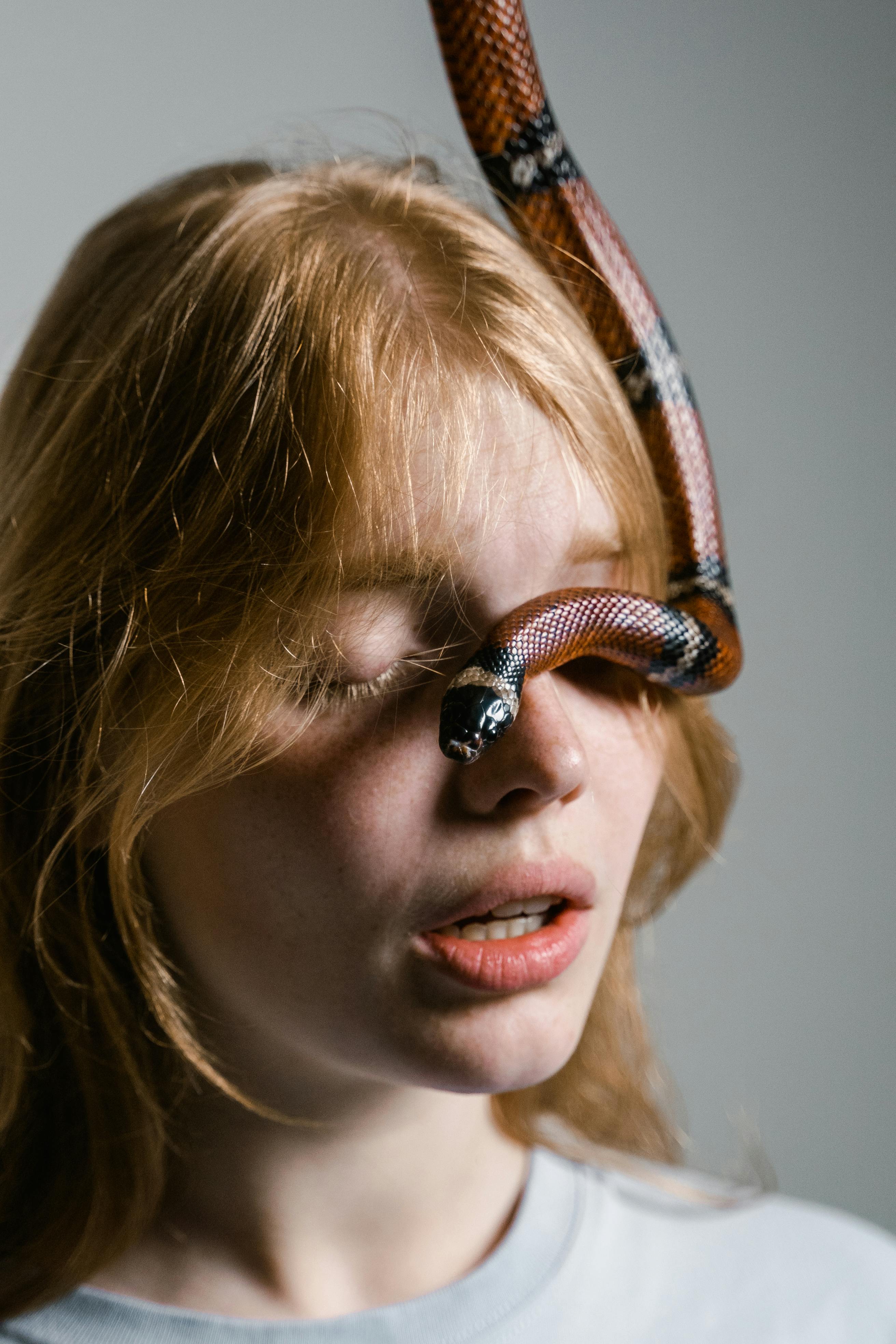 close up photo of a fearful woman having ophidiophobia