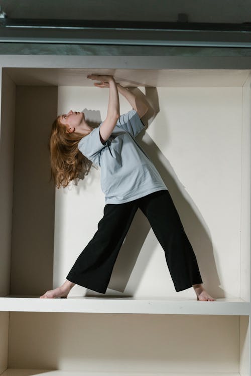 A Fearful Woman Having Claustrophobia in a Cabinet