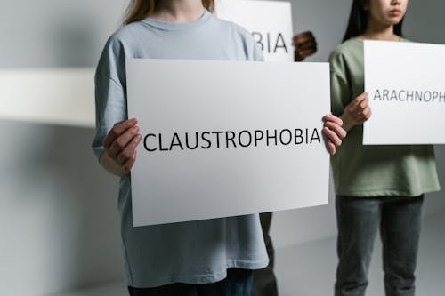 A Person Holding a Sign of Claustrophobia