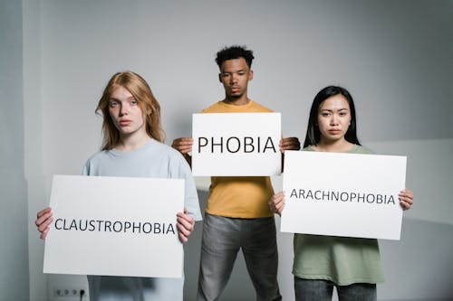 Free People Holding Signs of Different Forms of Phobia Stock Photo