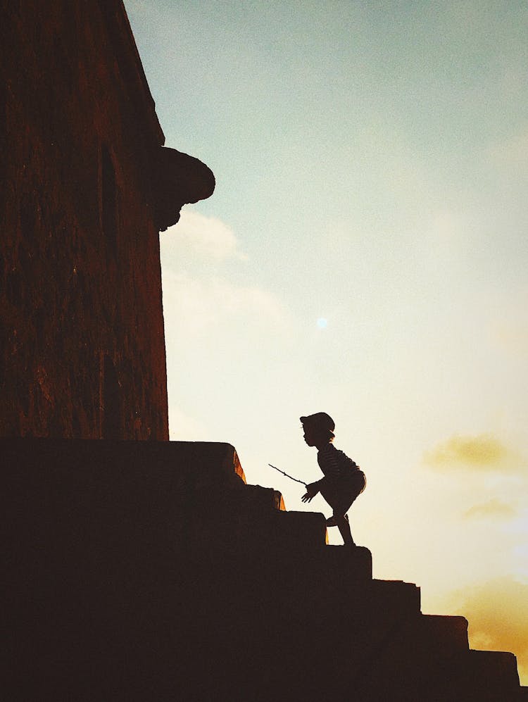 Silhouette Of Child Climbing Stairs