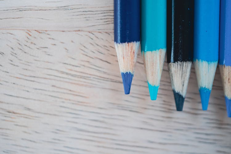 Blue Pencils On Wooden Table