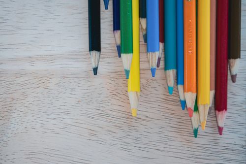 Free Bright close-up of colored pencils with sharpened tips on a wooden surface. Stock Photo